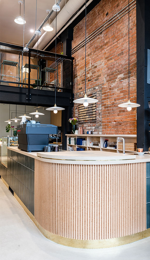 Saint Cecilia space with high ceilings, exposed brick and oversized windows